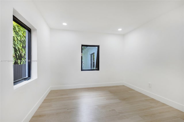 unfurnished room with light wood-type flooring