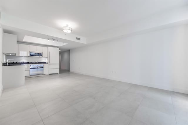 unfurnished living room featuring light tile patterned floors