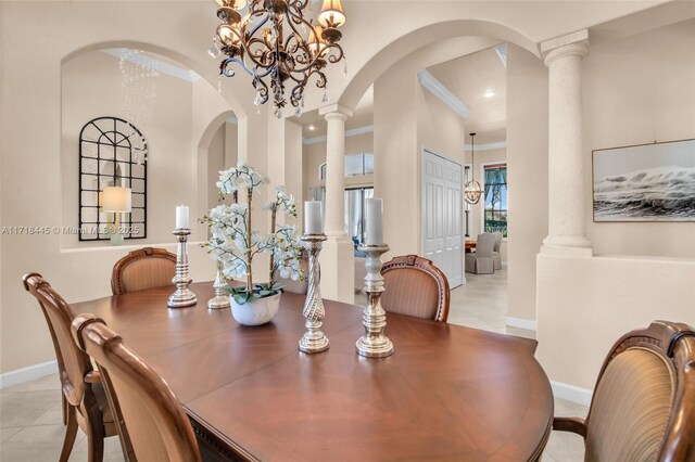 tiled dining area featuring an inviting chandelier, crown molding, and ornate columns