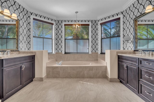 bathroom featuring tiled tub, crown molding, vanity, and a chandelier