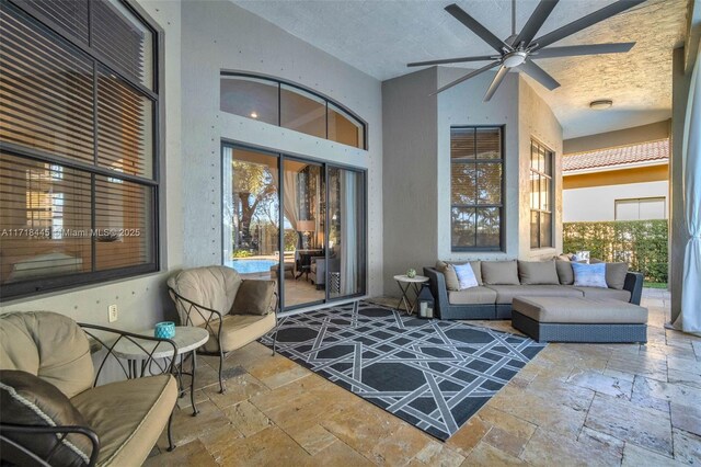 sunroom / solarium featuring ceiling fan and vaulted ceiling