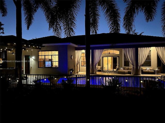 rear view of house with outdoor lounge area and a patio area