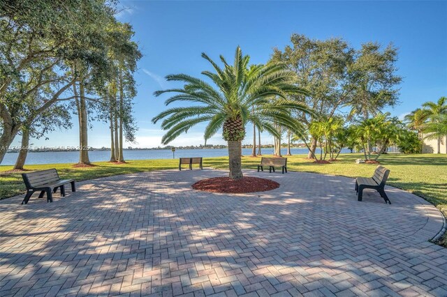 view of community featuring a yard and a water view