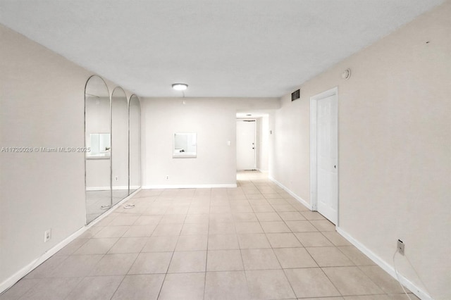 unfurnished room featuring light tile patterned floors