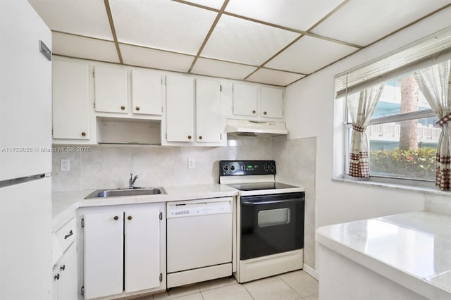 kitchen with backsplash, white appliances, sink, white cabinetry, and light tile patterned flooring