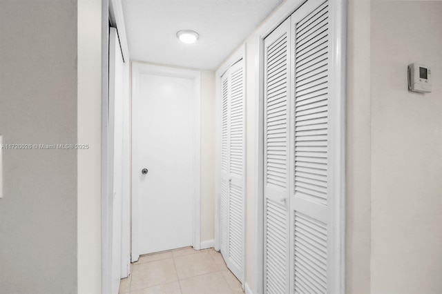 hallway featuring light tile patterned floors