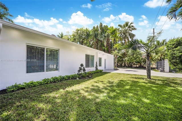 view of property exterior with a lawn