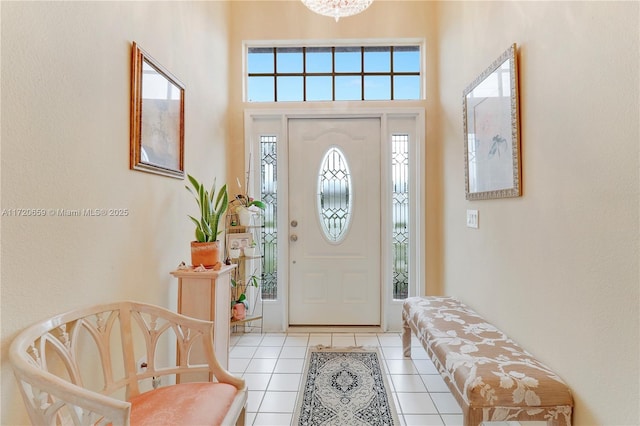 tiled foyer featuring a towering ceiling