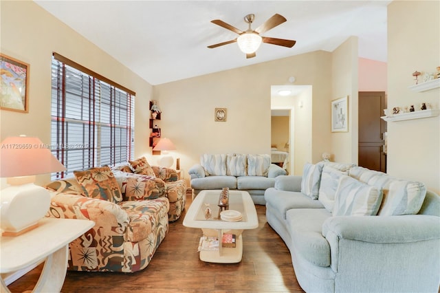 living room with ceiling fan, dark hardwood / wood-style flooring, and vaulted ceiling