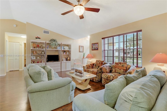 living room featuring ceiling fan, wood-type flooring, and vaulted ceiling