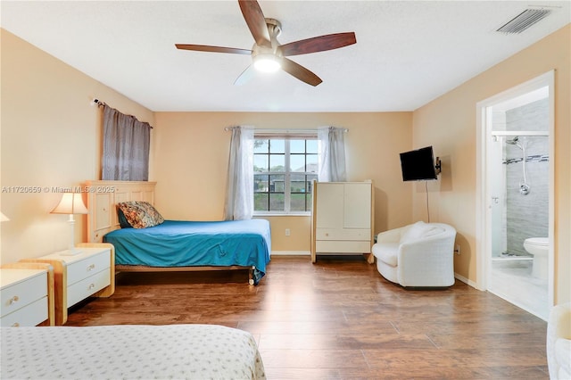 bedroom featuring connected bathroom, dark hardwood / wood-style floors, and ceiling fan