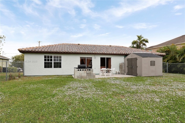 back of property featuring a yard, a storage shed, and a patio area