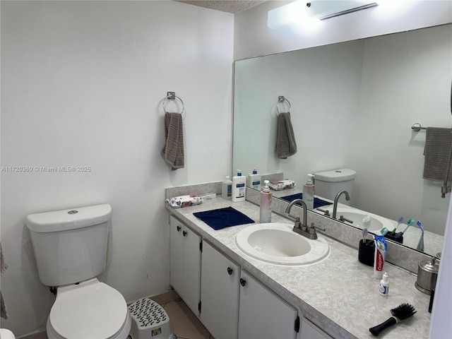 bathroom with toilet, tile patterned floors, and vanity