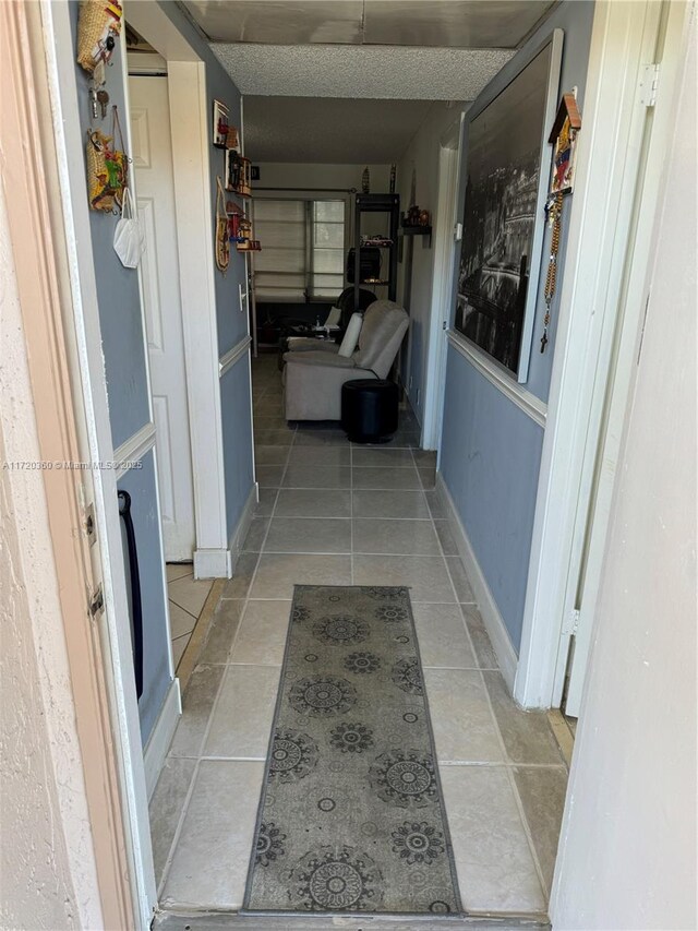 kitchen with tasteful backsplash, light tile patterned floors, and white appliances