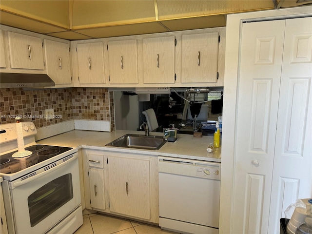 kitchen with light tile patterned flooring, ventilation hood, sink, backsplash, and white appliances