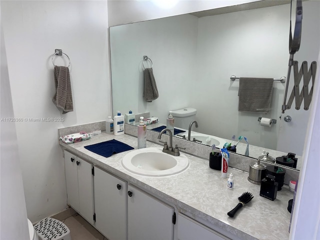 bathroom featuring vanity, toilet, and tile patterned flooring