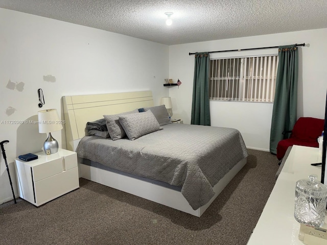 bedroom featuring a textured ceiling and dark colored carpet