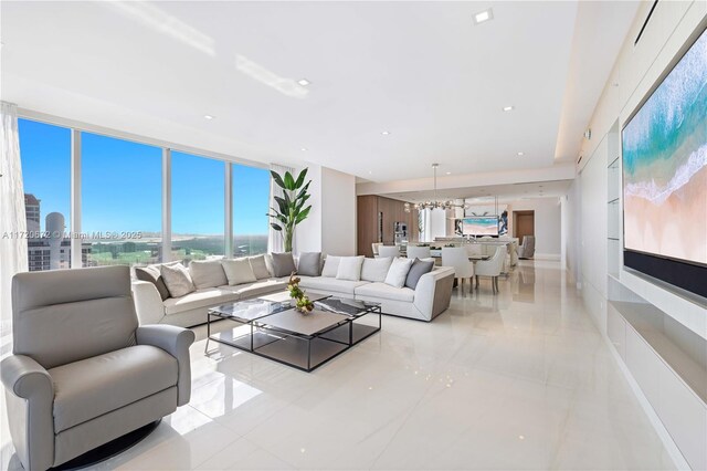 tiled living room featuring an inviting chandelier