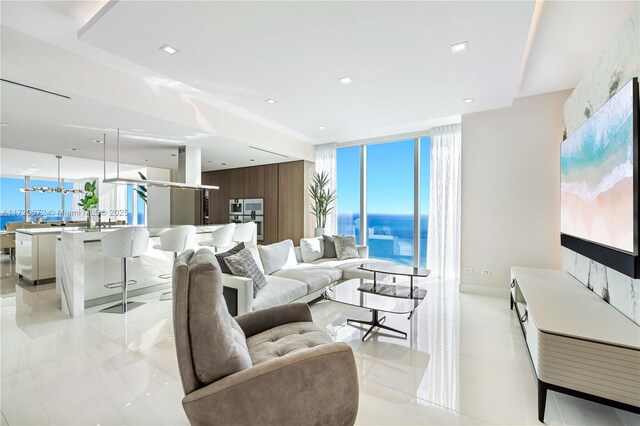 living room featuring a wealth of natural light, floor to ceiling windows, and wooden walls