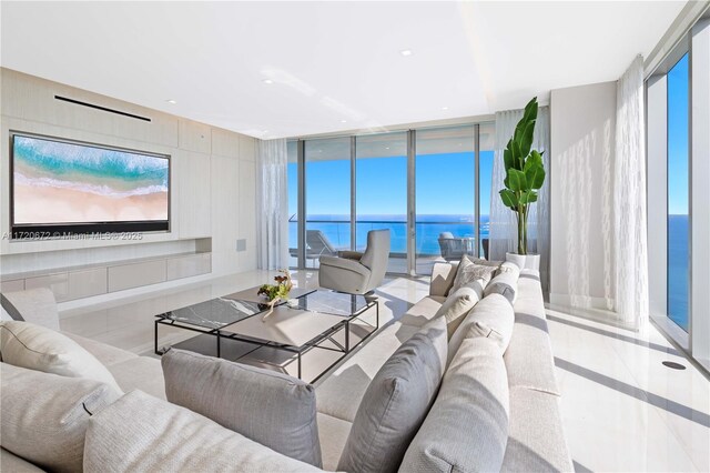 tiled living room with floor to ceiling windows and a water view