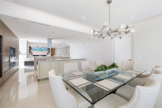 dining area with light tile patterned floors, a notable chandelier, wooden walls, and sink