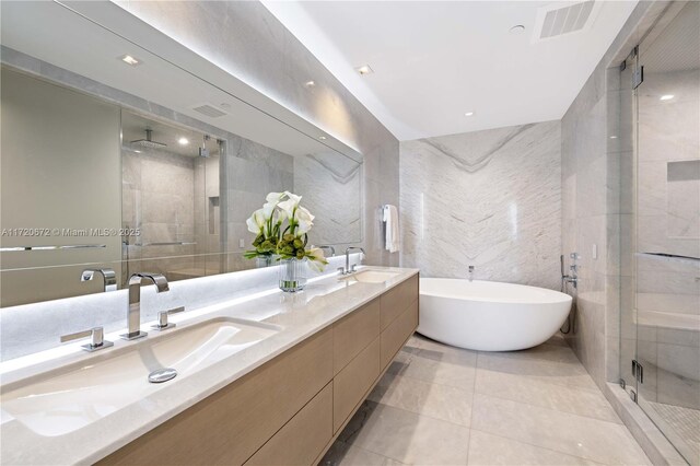 bathroom with vanity, tile patterned floors, tile walls, and independent shower and bath