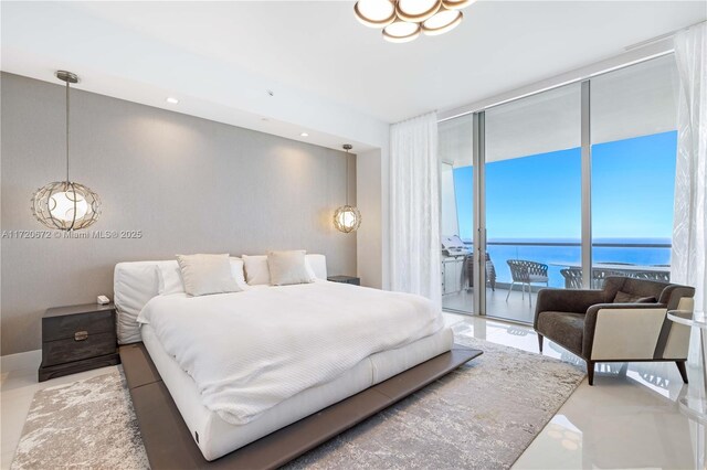 bedroom featuring a water view, a wall of windows, and access to outside