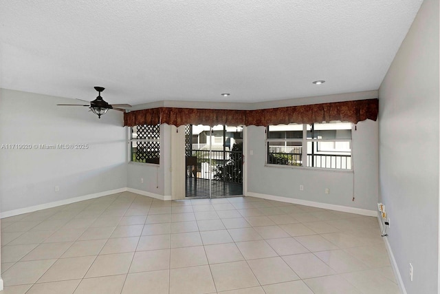 unfurnished room featuring light tile patterned floors, a textured ceiling, and ceiling fan