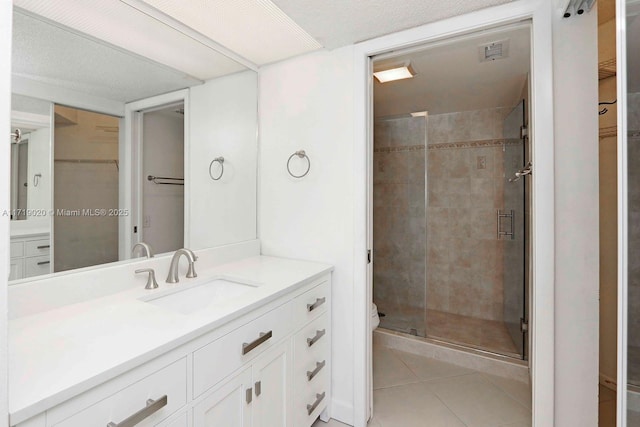 bathroom featuring tile patterned flooring, vanity, and an enclosed shower