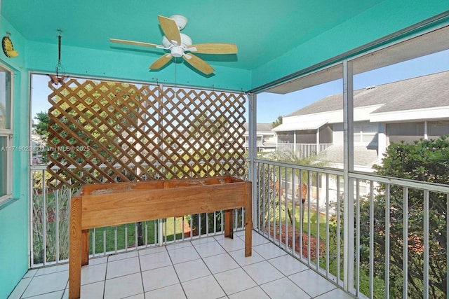 unfurnished sunroom with ceiling fan