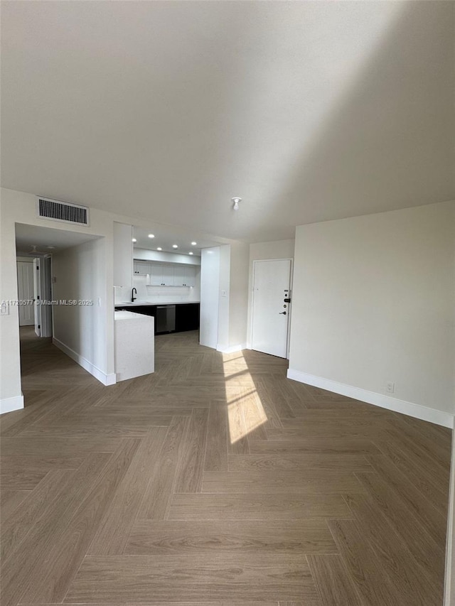 unfurnished living room featuring parquet flooring