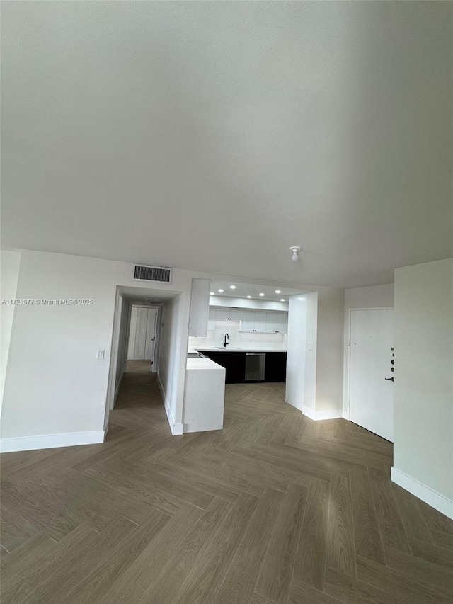 unfurnished living room featuring dark parquet flooring