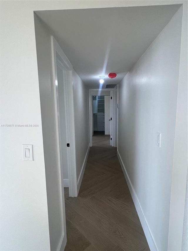 hall with dark parquet flooring