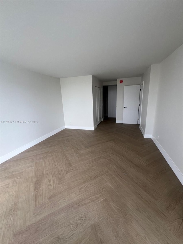 empty room with parquet flooring