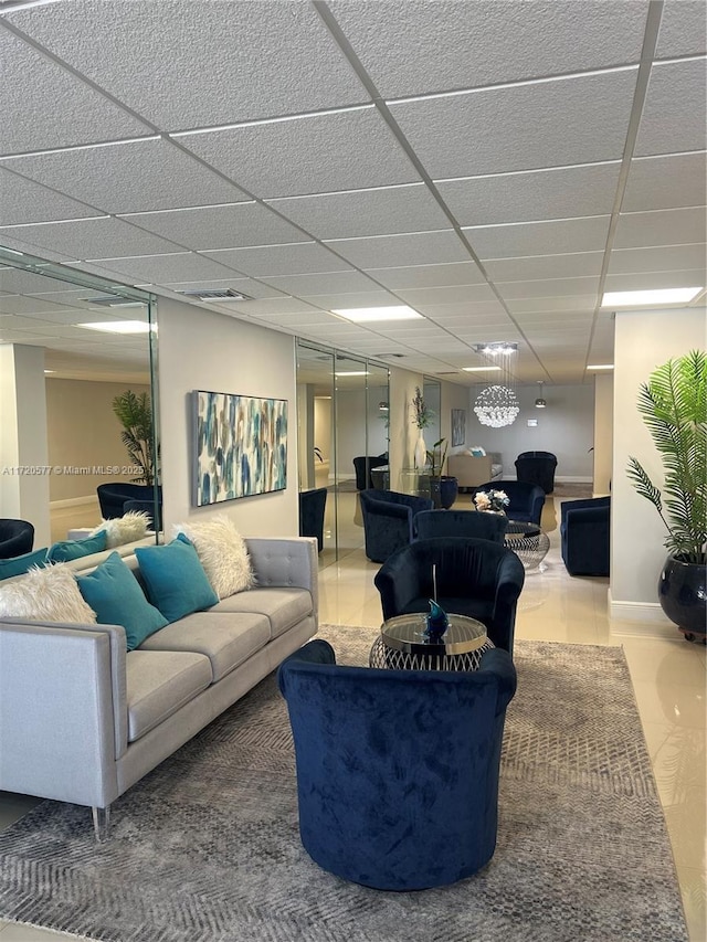 living room featuring a drop ceiling