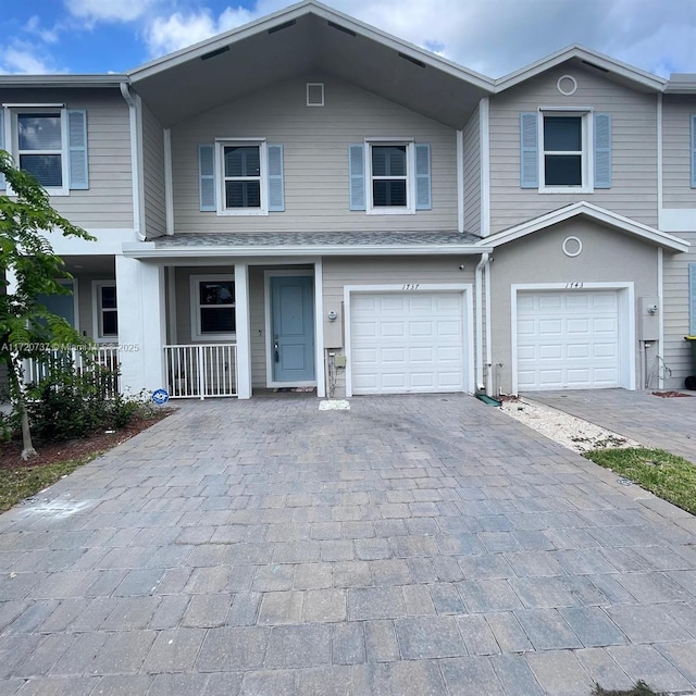 view of front of home with a porch and a garage