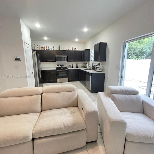 kitchen featuring sink, light tile patterned floors, and stainless steel appliances