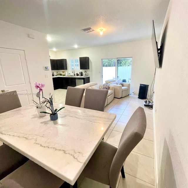 dining room with light tile patterned flooring and sink