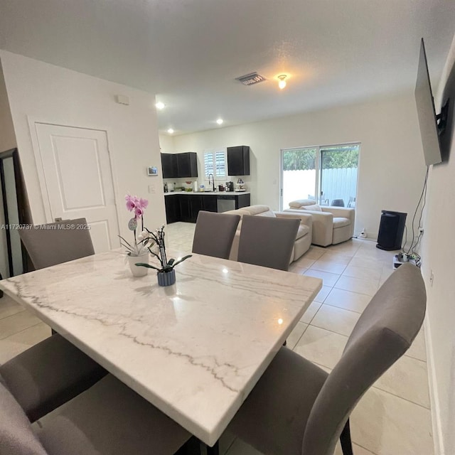 tiled dining space featuring sink