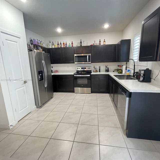 kitchen featuring sink, light tile patterned floors, and stainless steel appliances