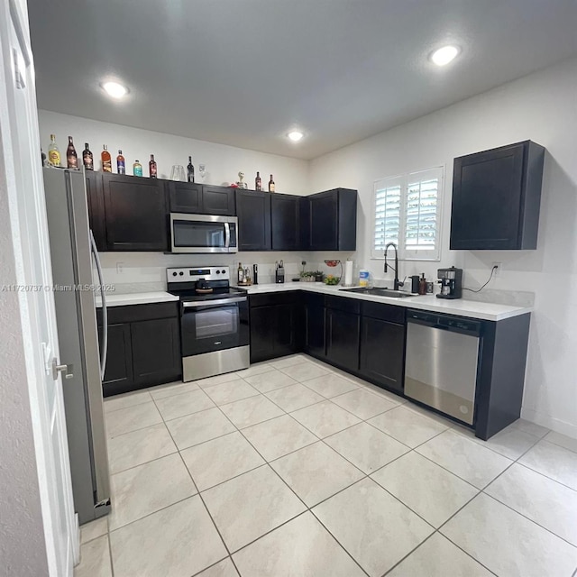 kitchen featuring sink, light tile patterned floors, and stainless steel appliances