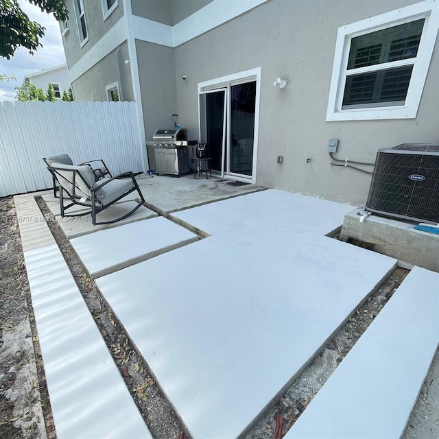 view of patio / terrace featuring a grill and cooling unit