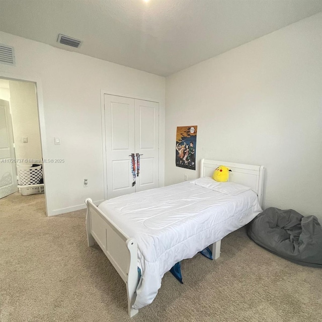 bedroom with a closet and light colored carpet