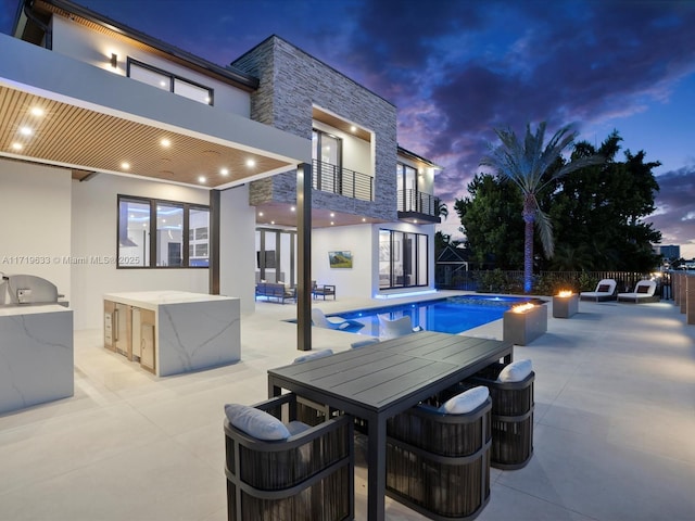 view of pool with a fenced in pool, a patio, area for grilling, outdoor dining space, and fence