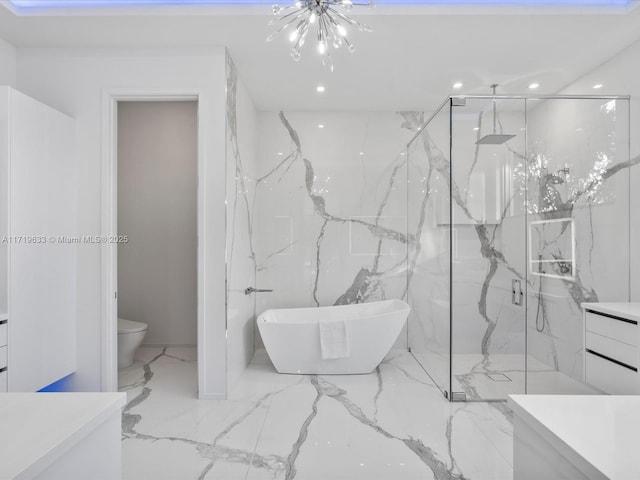 full bath featuring a marble finish shower, toilet, a soaking tub, marble finish floor, and stone wall