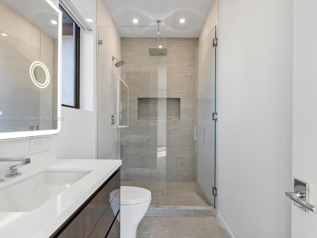 bathroom with toilet, a shower stall, tile patterned flooring, and vanity