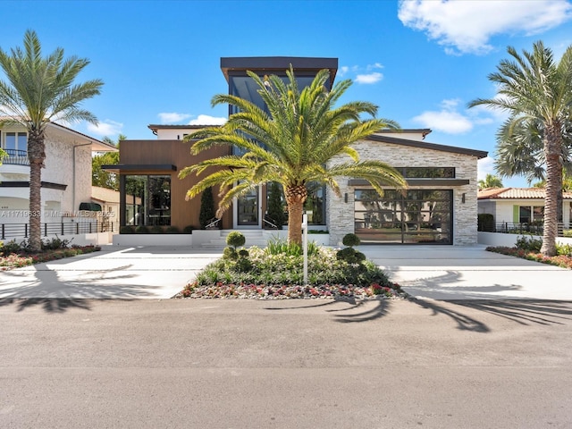 view of property featuring fence and concrete driveway