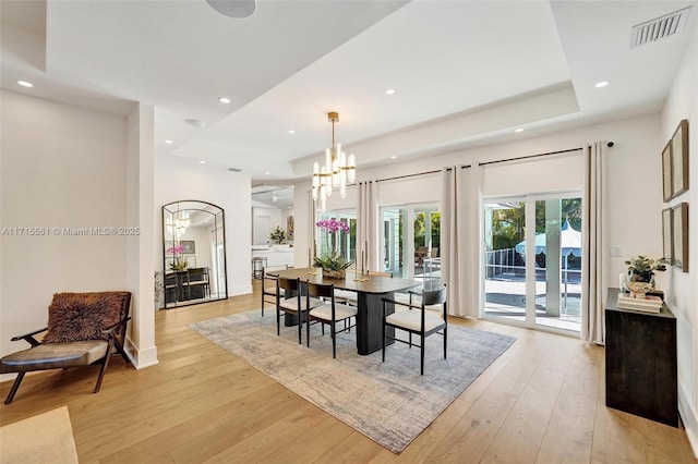 dining room featuring a notable chandelier and light hardwood / wood-style flooring