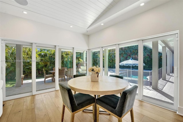 sunroom / solarium featuring wood ceiling and vaulted ceiling