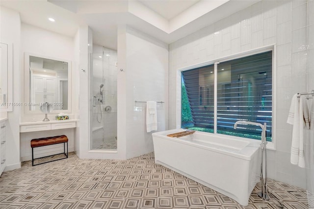 bathroom featuring vanity and separate shower and tub